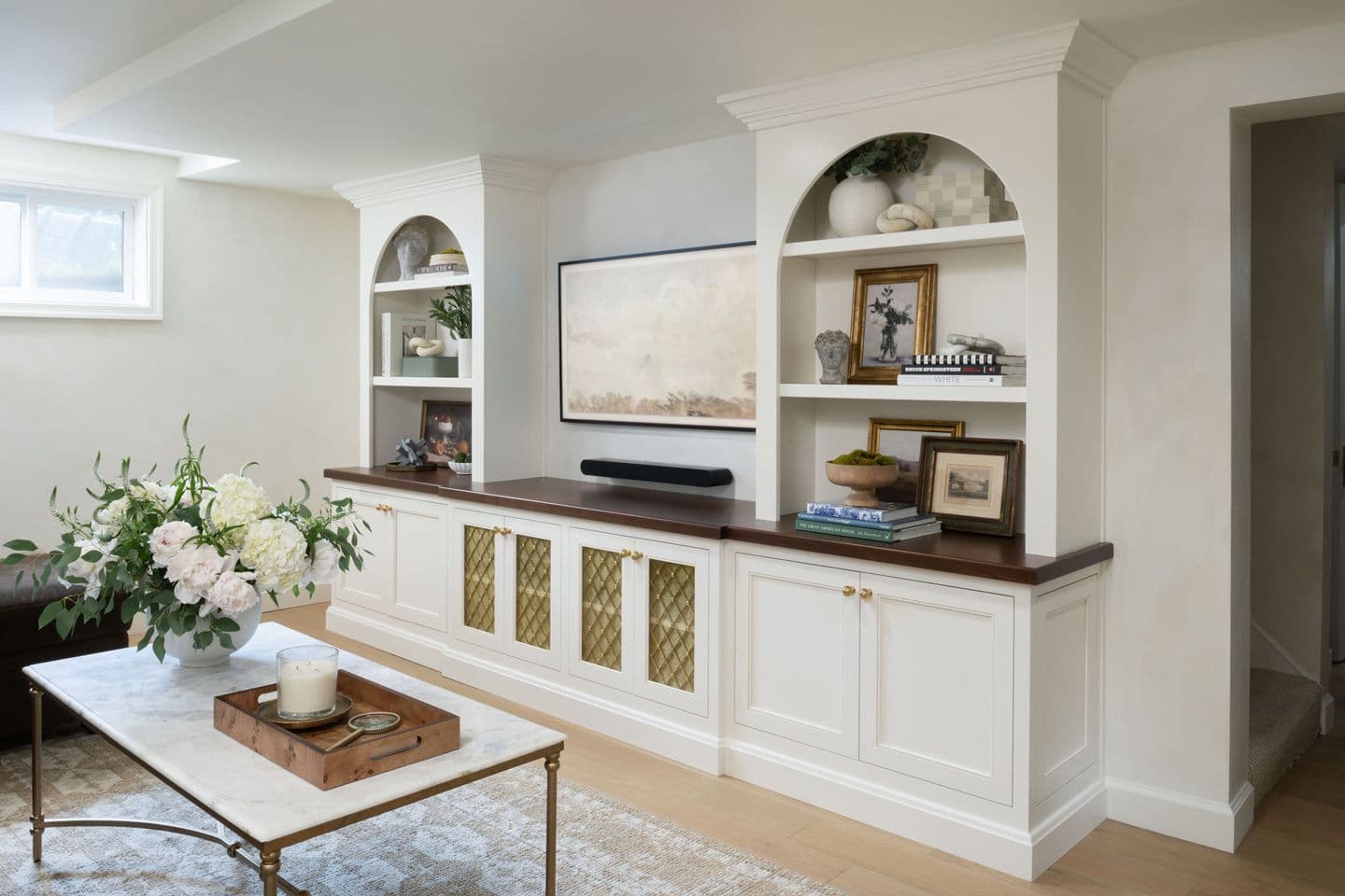Entertainment center with white cabinets by Bethesda Contracting